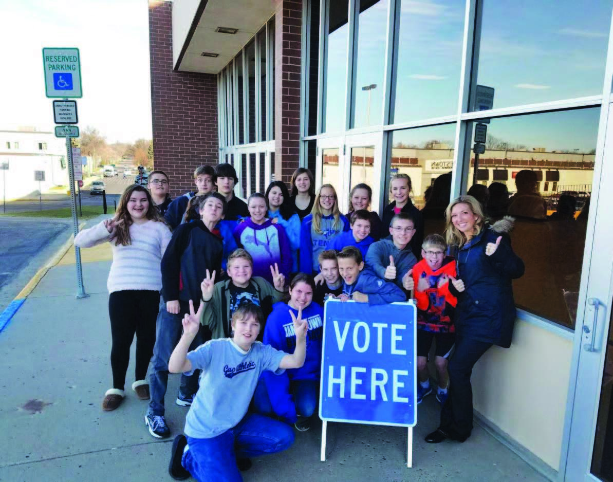 Image of students at voting facility-vote here.